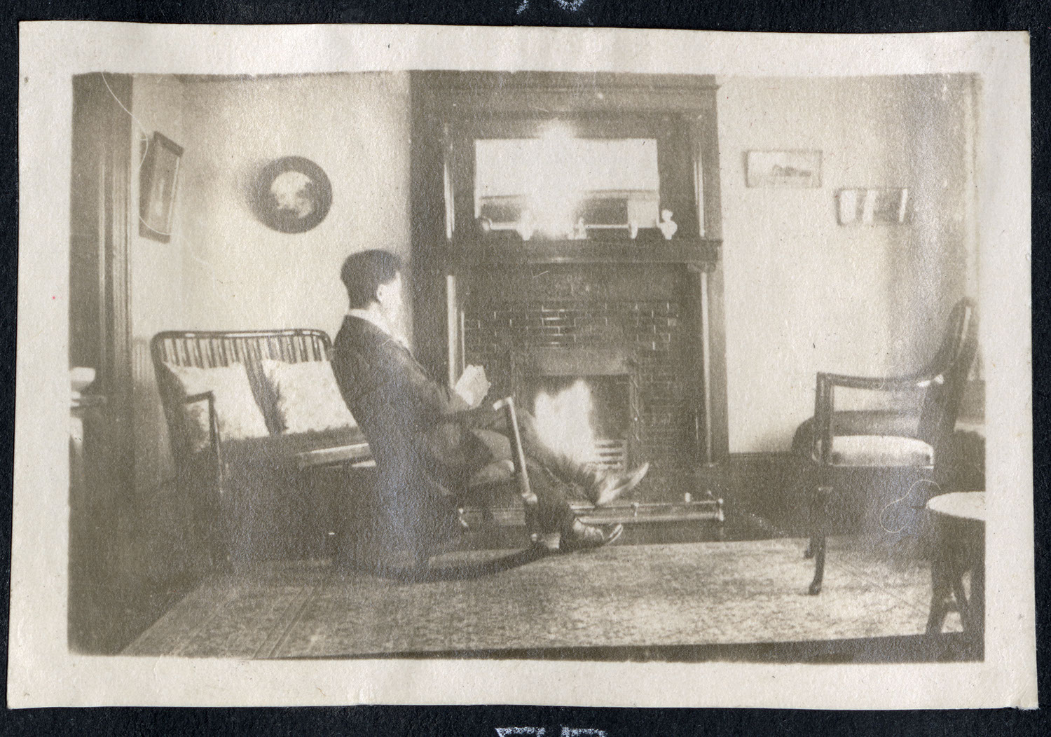 A man sitting in a living room by the fire